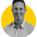 A monochrome photo of Ian against a yellow background
