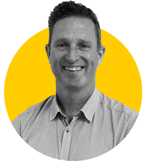 A monochrome photo of Ian against a yellow background