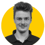 A monochrome photo of Tom against a yellow background