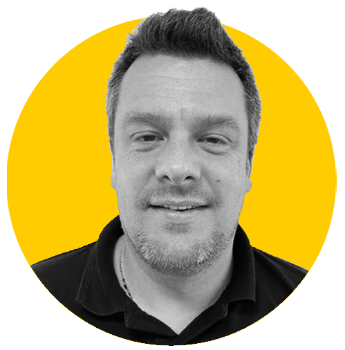 A monochrome photo of Tim against a yellow background